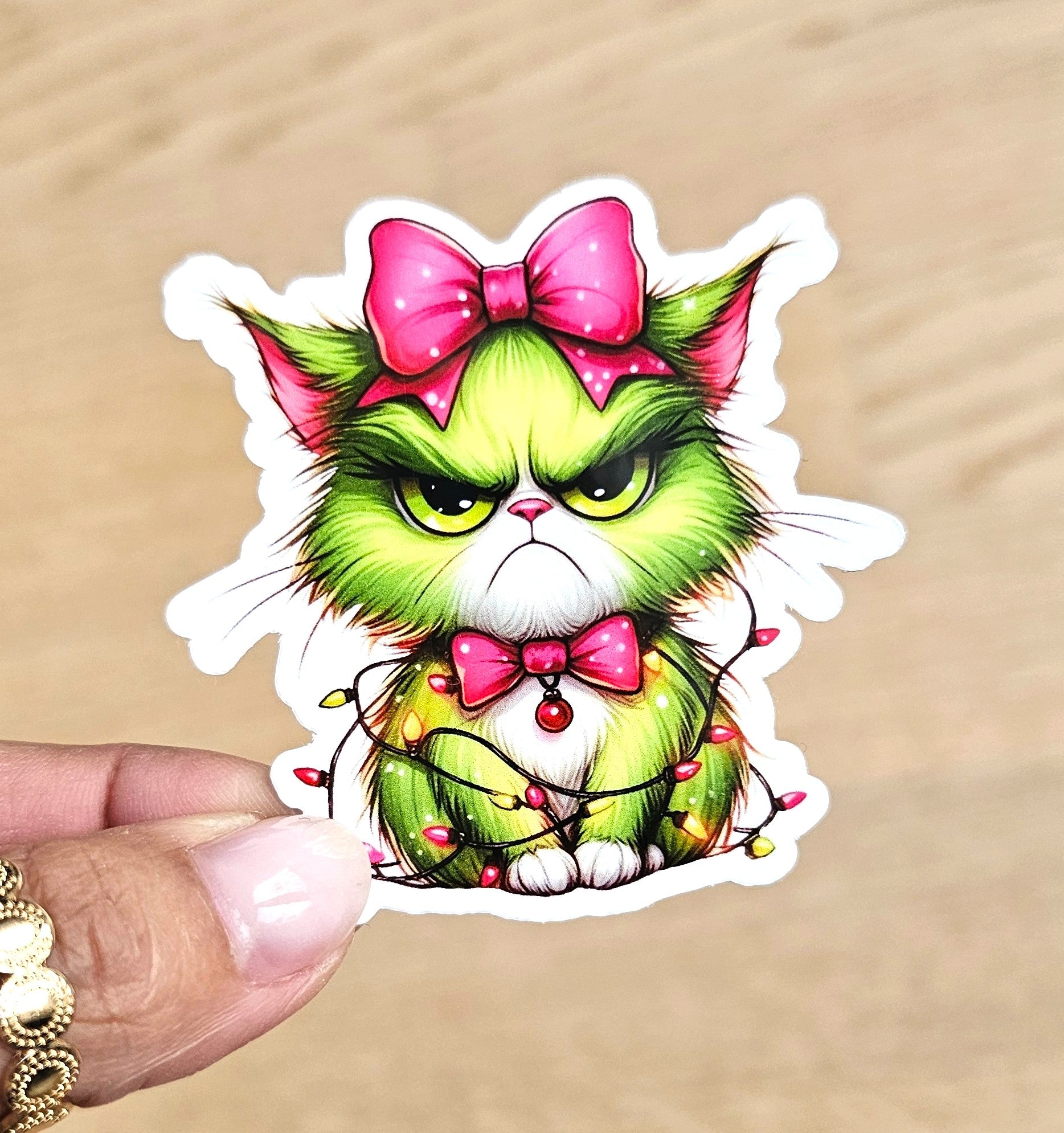 Sticker chat de Noël grincheux - Guirlande et nœud rose
